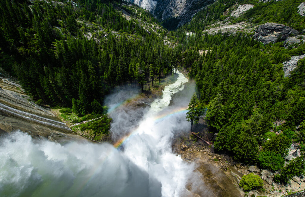 Nevada Water Falls creating a rainbow before the water falls onto the land at Yosemite National Park -