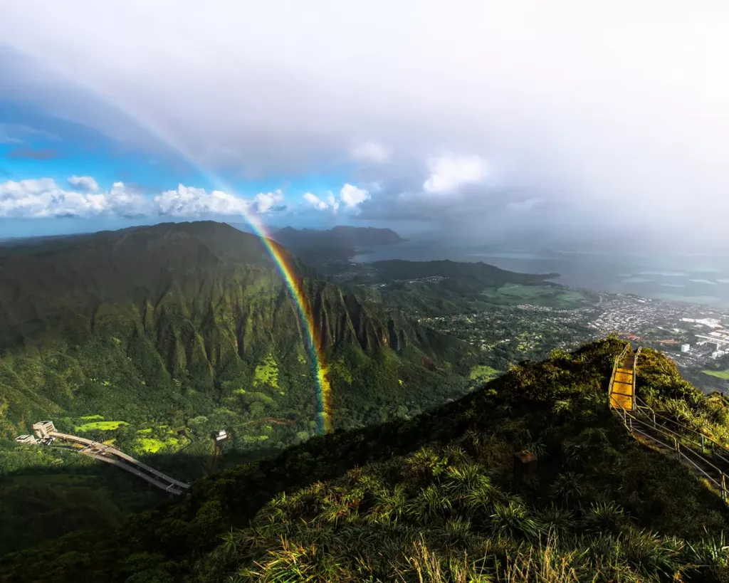 Image of Haiku Stairs on a mountain in Hawaii with clouds and rainbows in the sky- Photograph by Hawaii Nature Photographer Raymond Enriquez Photography